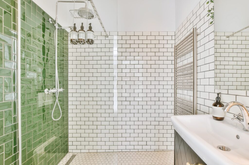beautiful shower tile installation with white subway tile and green tile