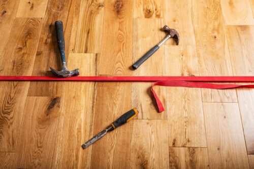 flooring installer tools on hardwood floor