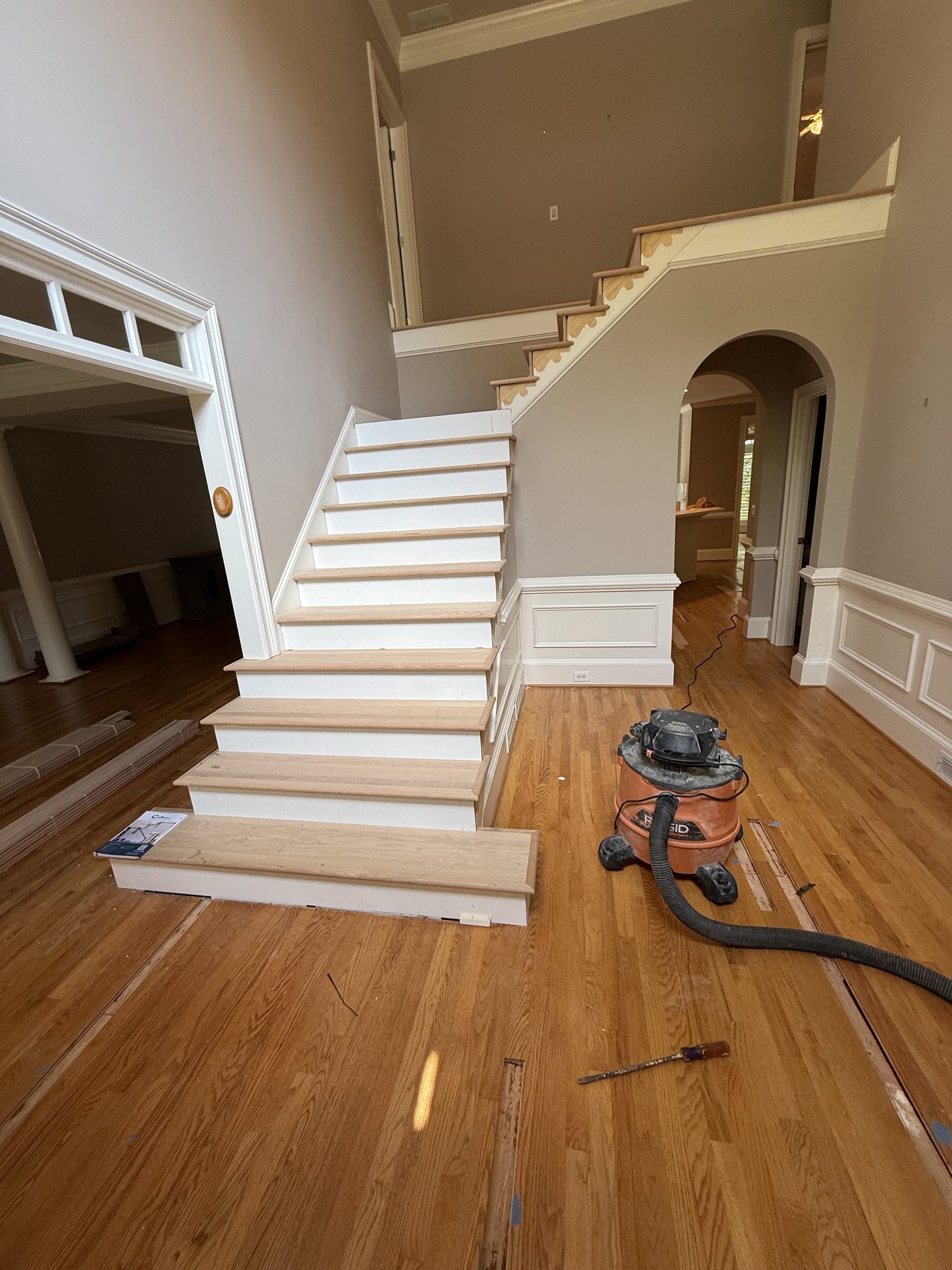 Staircase refinishing in a two-story Alpharetta, GA foyer by Atlanta Floor One
