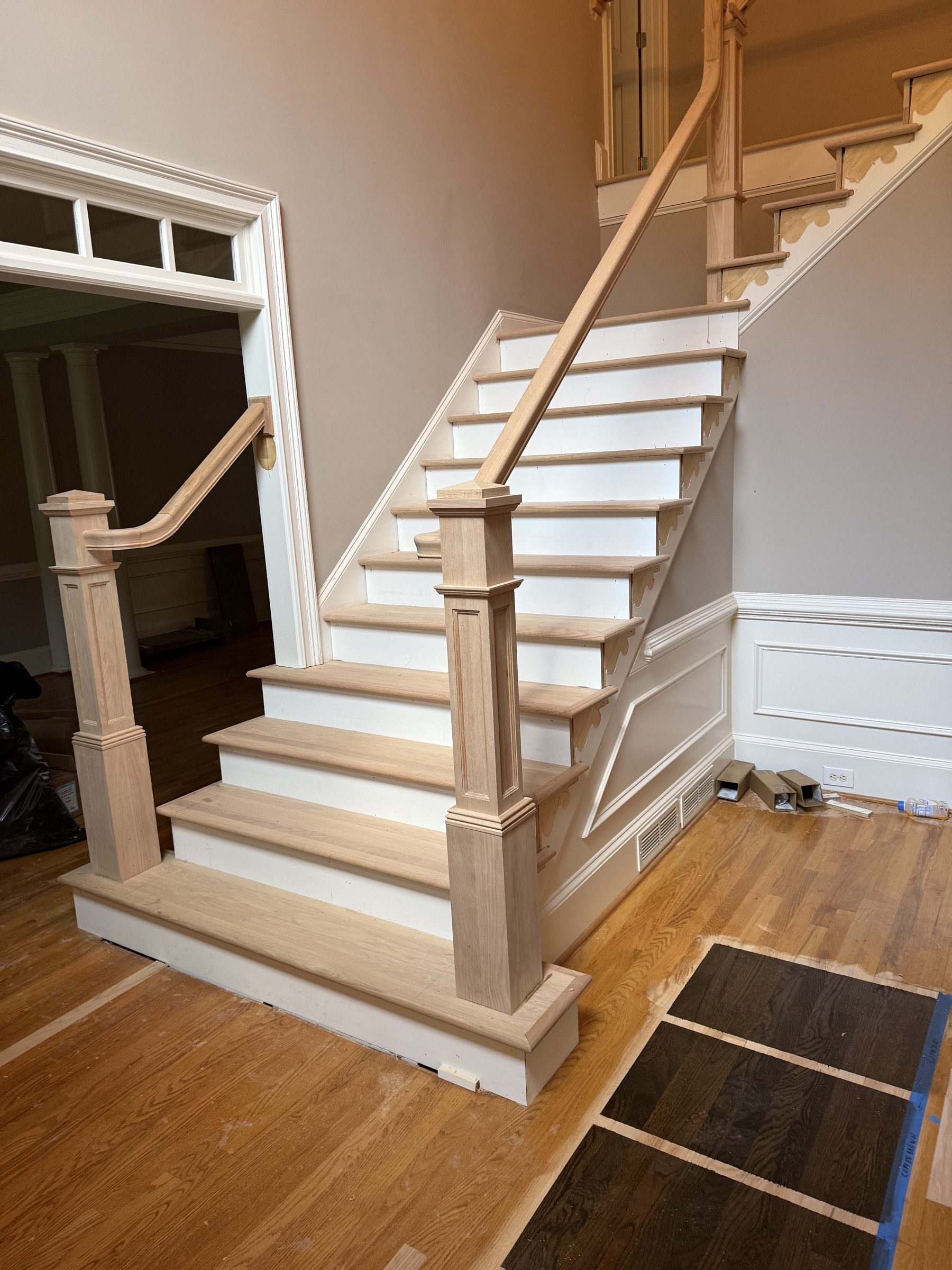 Staircase refinishing in a two-story Alpharetta, GA foyer by Atlanta Floor One