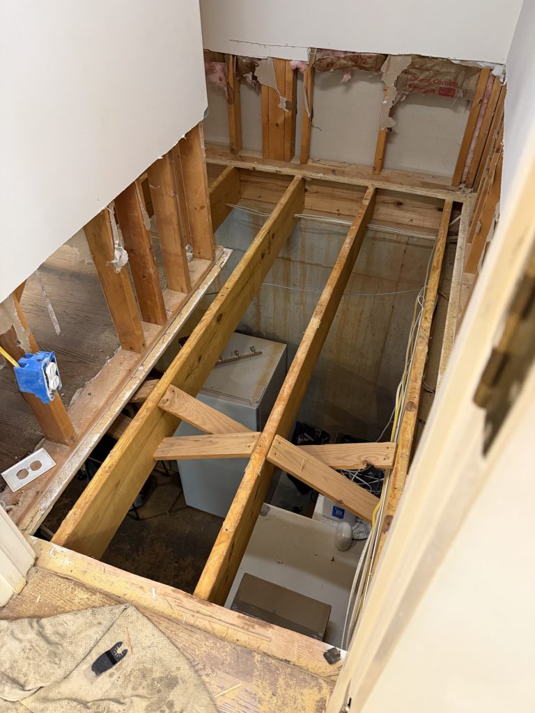 Subfloor repair in a Milton, GA home with the floor opened down to the joists, by Atlanta Floor One