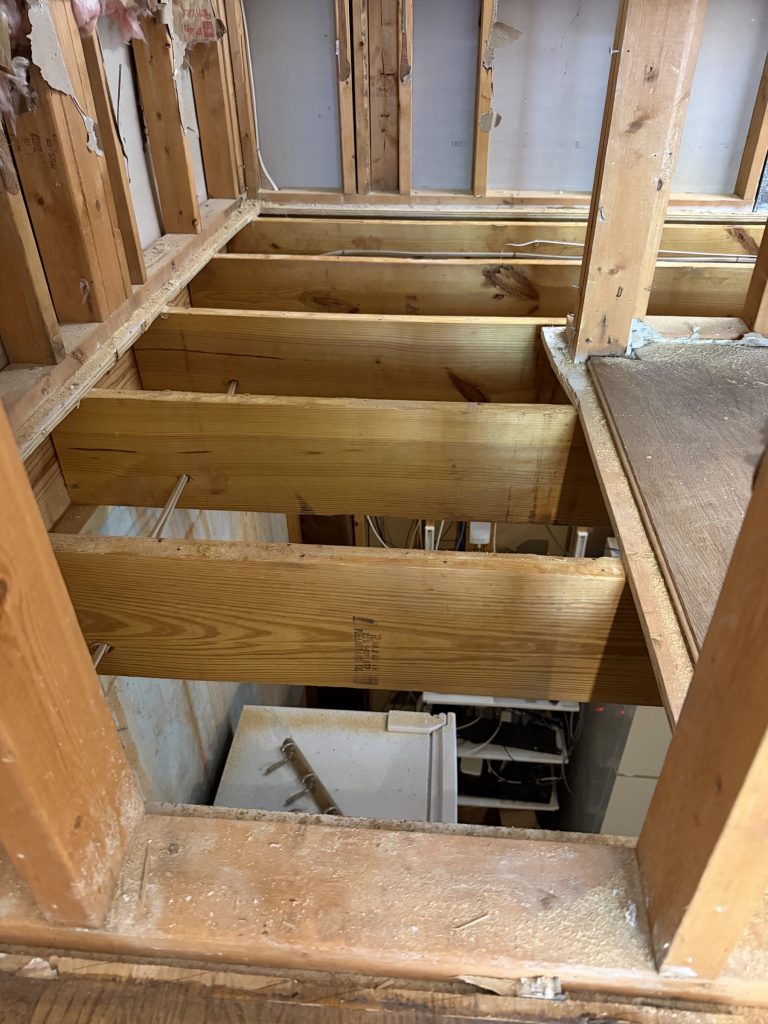 Exposed floor joists during a subfloor repair in a Milton, GA home by Atlanta Floor One