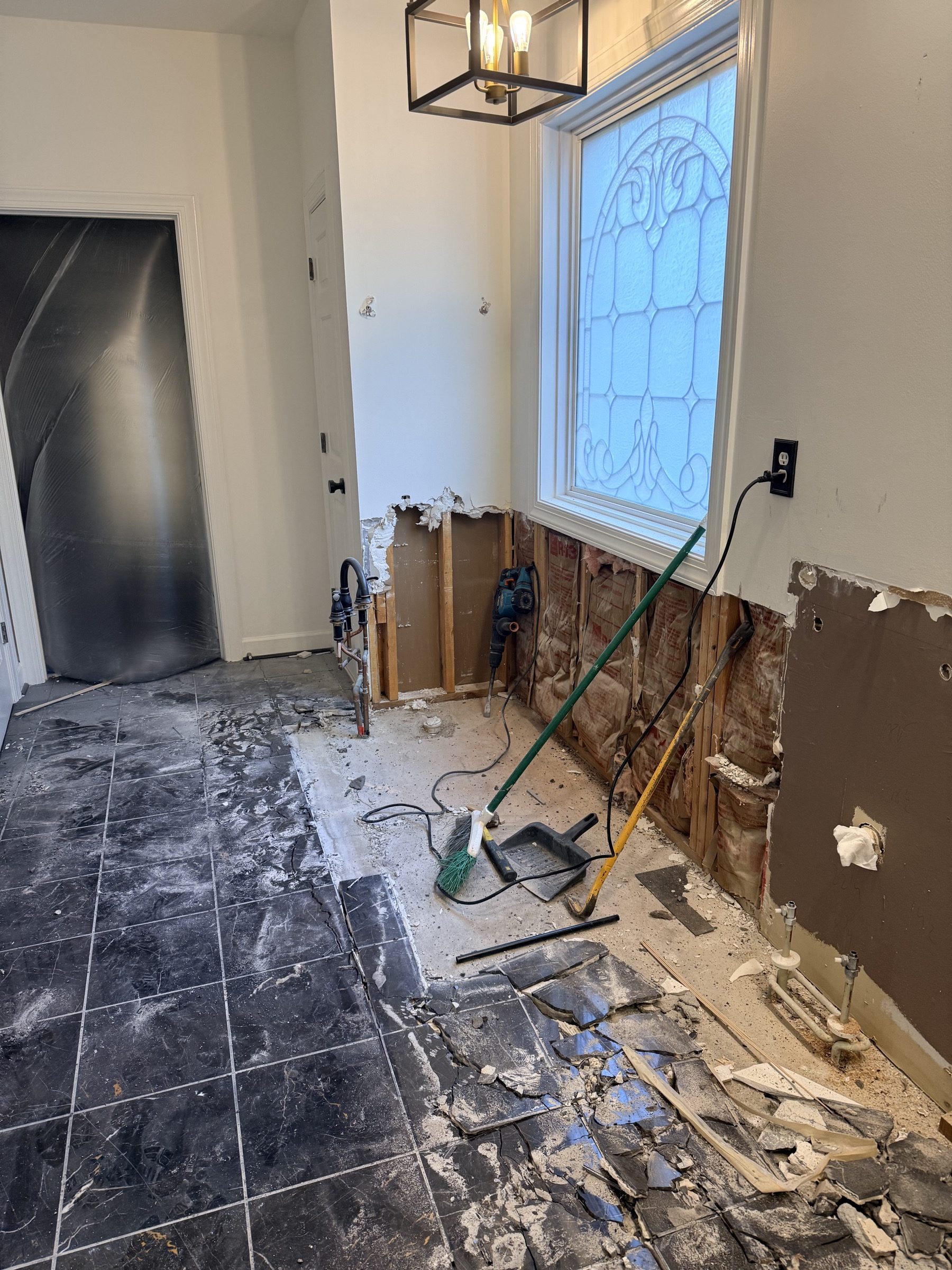 Master bathroom demolition in a Roswell, GA home with the old tile floor lifted and the walls opened to the studs, by Atlanta Floor One