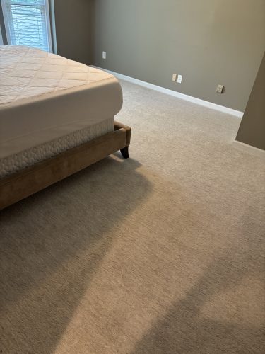 Freshly installed bedroom carpet in a Duluth, GA home, stretched tight to clean baseboard edges