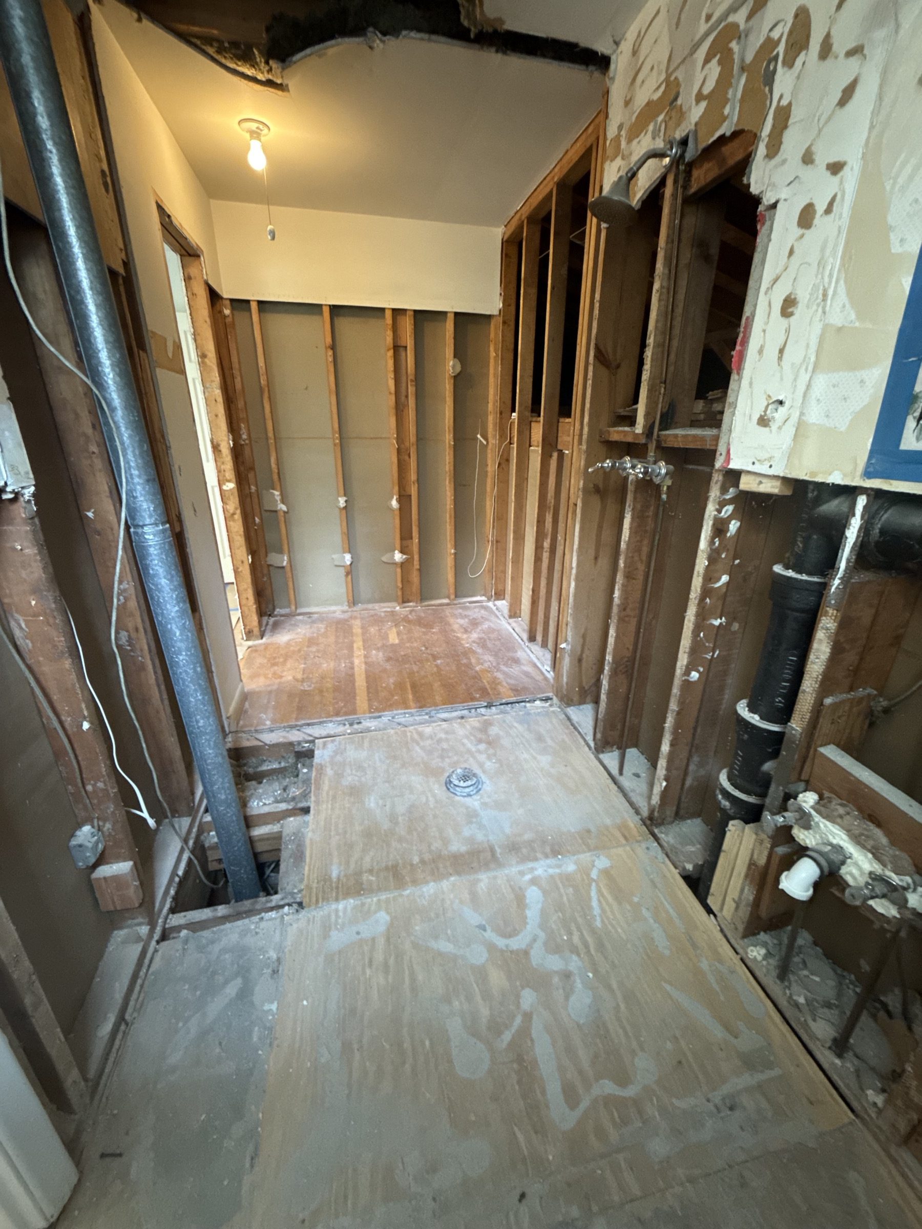 Sandy Springs GA bathroom remodel demo - walls opened to the studs and subfloor before tile installation by Atlanta Floor One