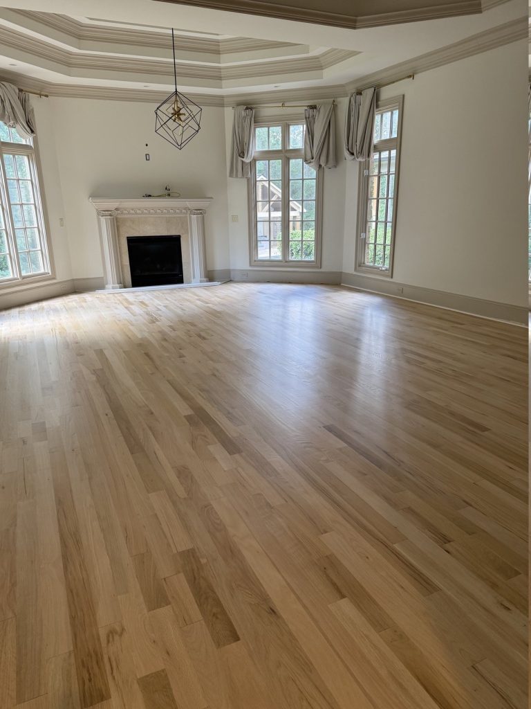 Great room hardwood floor in a Suwanee, GA home after sanding and a clear natural finish, by Atlanta Floor One