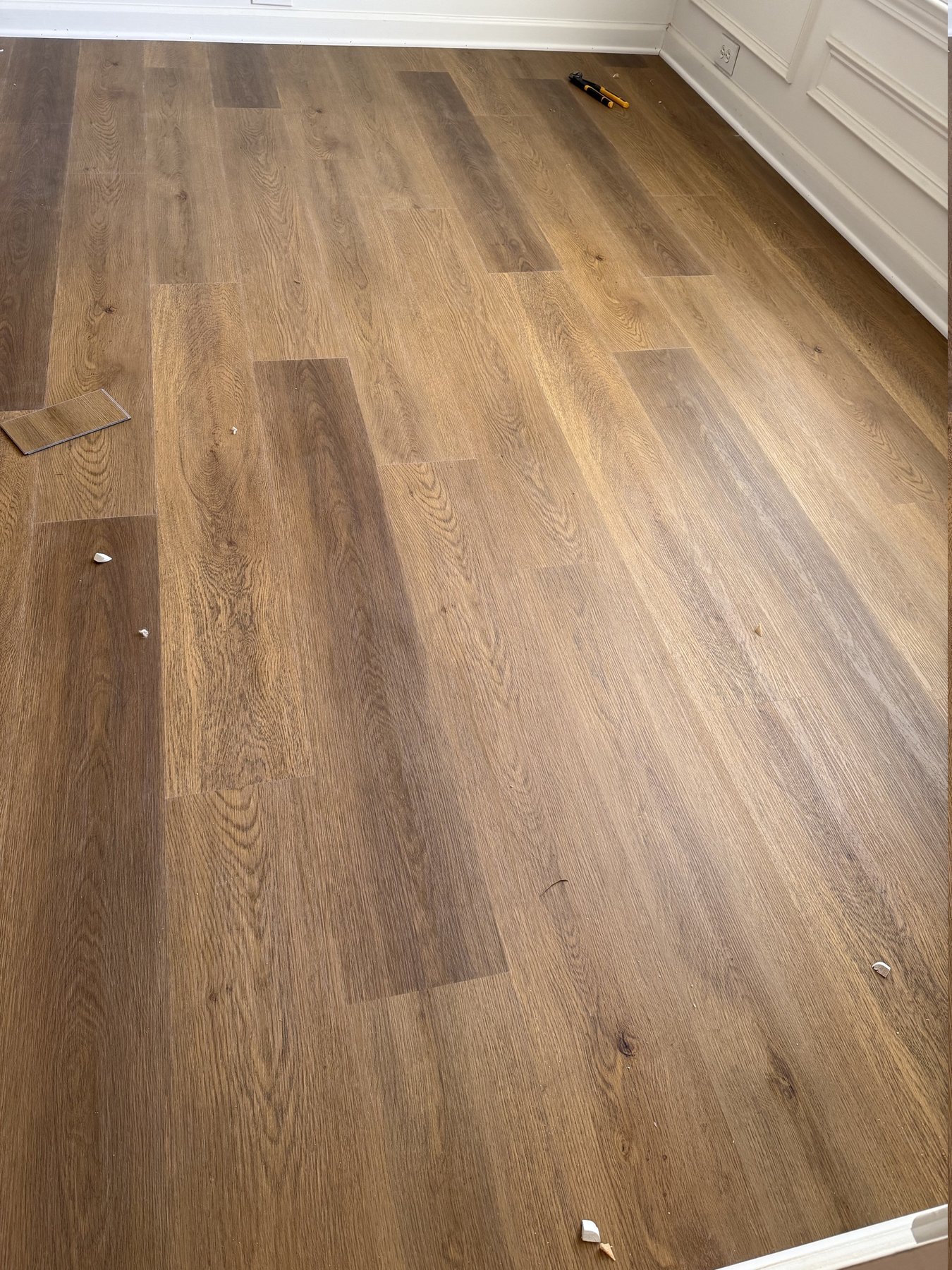 Close-up of wood-look luxury vinyl plank flooring with staggered end joints, installed in an Alpharetta, GA home