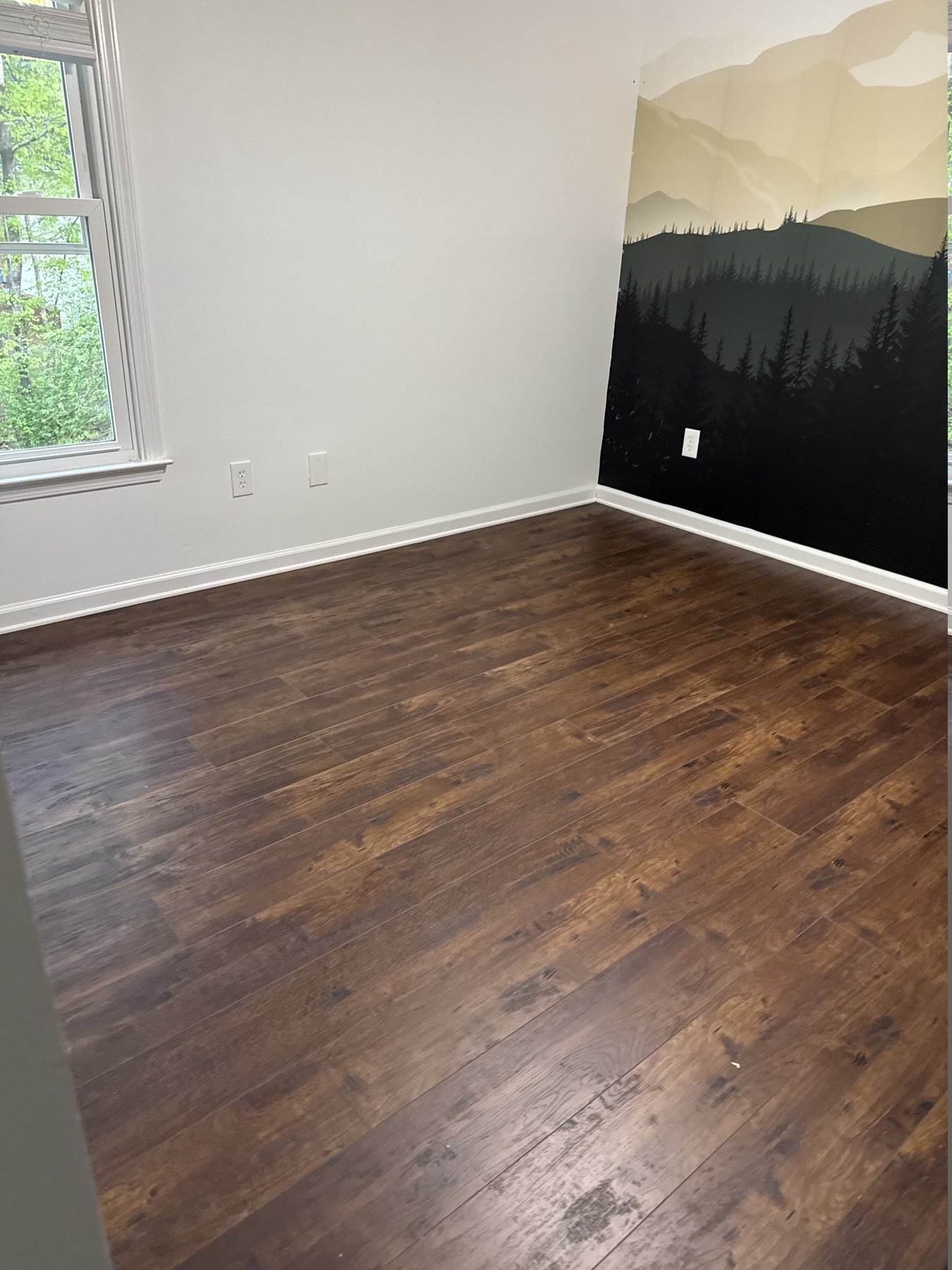 Finished bedroom with new dark distressed plank flooring running the length of the room, flooring installation by Atlanta Floor One
